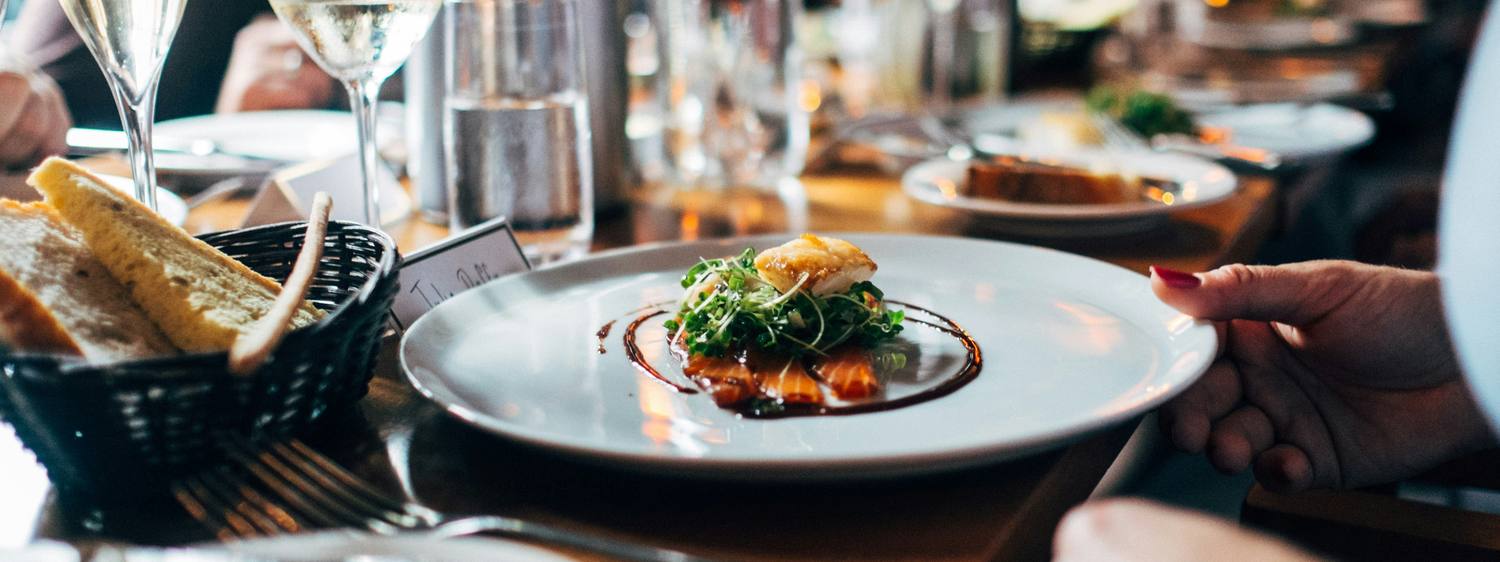 A plated dish being served in a restaurant